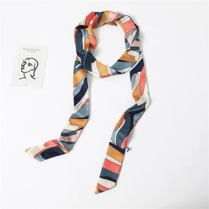 Close-up of abstract geometric print silk twilly scarf with neat diagonal cut ends