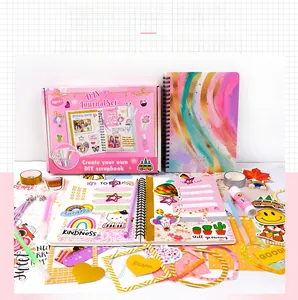 Macro shot of children's DIY journal kit including stickers, pens, and a spiral notebook