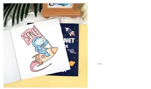 Detailed view of space-themed coloring book showing astronaut and rocket illustrations