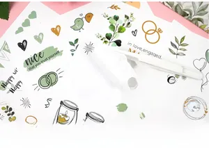 Detailed view of hand-drawn wedding guest book stickers with gold foil and floral motifs