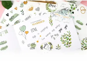 Detailed view of elegant wedding stickers set with gold foil leaves and love quotes