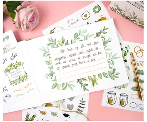 Detailed wedding guest book set with botanical stickers and gold foil message cards
