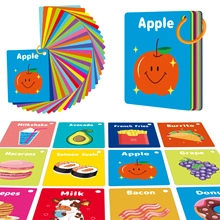 Macro detail of toddler flashcards showing colorful food patterns and a yellow binder ring