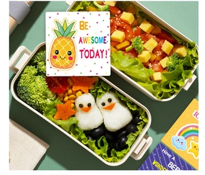 Detail of cartoon pineapple lunch box note with Be Awesome Today message on food