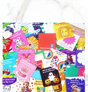 Detailed spread of 60 colorful cartoon kids lunchbox riddle cards on marble background