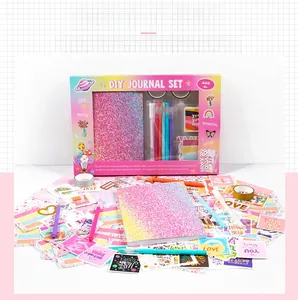 Close-up of DIY scrapbook kit featuring gradient glitter notebook and assorted stickers
