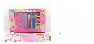 DIY journal set detail featuring glitter notebook, stickers, stamps, and tape in gift box