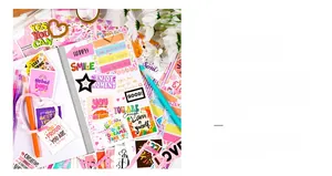 Close-up of DIY scrapbook stickers with inspirational English quotes like SMILE and STAY STRONG