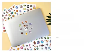 Detail of colorful cartoon stickers on a laptop including animals and floral patterns