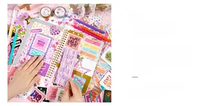 Flat lay of DIY journal set with heart stickers, colorful pens and washi tapes for kids