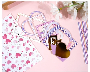 Detail of DIY scrapbook kit featuring gold foil stickers and pink heart frames for crafts