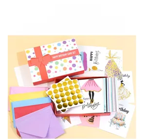 Flat lay of colorful 100-piece birthday card set with envelopes and gold stickers