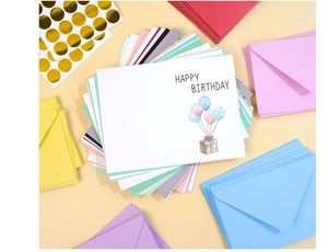 Close-up of colorful birthday card set with envelopes and gold foil seal stickers