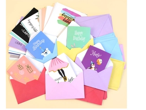 Close-up of colorful birthday card set with 100 cartoon illustrations and gold foil stickers