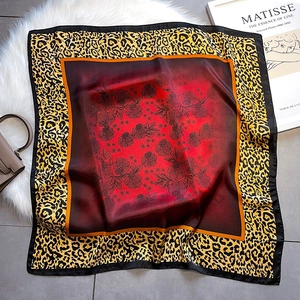 Elegant leopard print silk scarf with red gradient and black floral pattern details