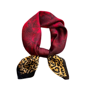 Elegant silk scarf with leopard print and red floral patterns on a white background