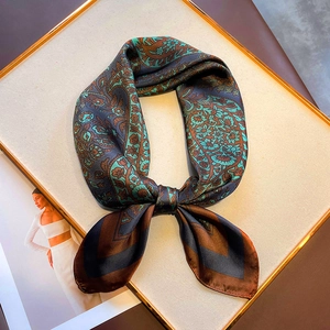Detail view of retro paisley silk scarf with blue and brown patterns on display