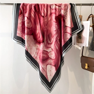 Detail of rose red and white marble pattern silk scarf hanging on a metal rod