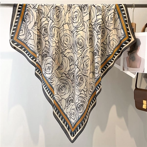 Detail of silk-feel large square scarf with artistic black rose print and striped borders