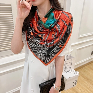Detail of colorful abstract patterned silk scarf worn as a stylish shawl wrap