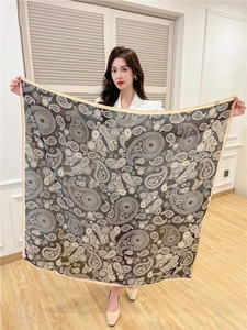 Flat lay of 110cm silk square scarf with vintage paisley print and beige borders