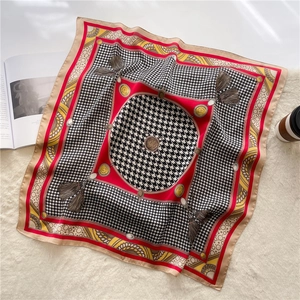Detail of silk-like square scarf featuring houndstooth pattern and vintage chain prints