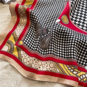 Detail of red and gold chain patterns on a classic houndstooth silk scarf on fur