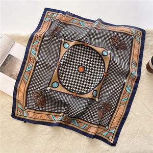 Detail of square houndstooth silk scarf with vintage jewelry print on plush background
