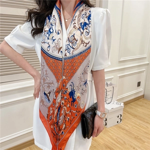 Detail of vintage equestrian print silk scarf with classic orange and navy blue patterns