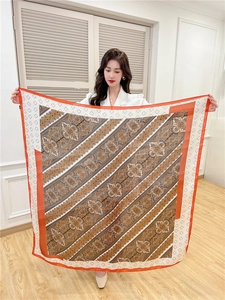 Detail of a 110cm silk-like scarf with orange vintage paisley print and rhombus border