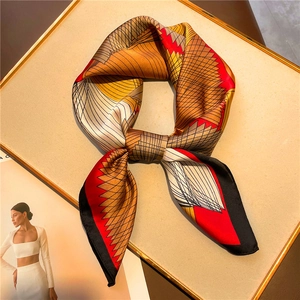 Elegant geometric print silk scarf 70x70cm with colorful patterns on a luxury display tray