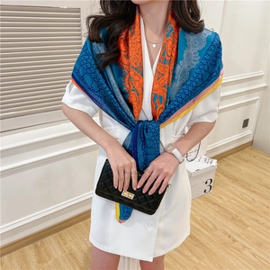 Detail of silk-like floral scarf with geometric patterns and bohemian colorful prints