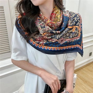 Detailed pattern of a 110cm vintage floral silk scarf styled on a female model
