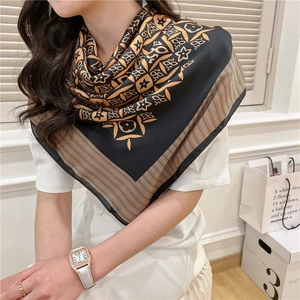 Detail of vintage 110cm square silk-like scarf with black and gold floral geometric patterns