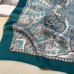 Detailed view of vintage paisley silk scarf featuring deep green borders and mandala patterns