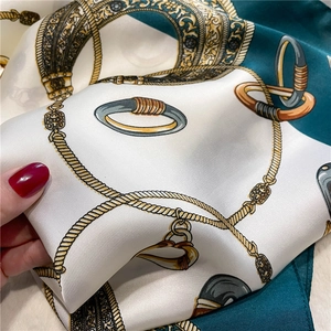 Detailed close-up showing the premium satin texture and equestrian chain pattern on scarf