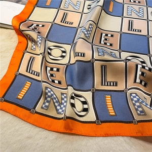 Detail showing colorful letter patterns and plaid texture on 70cm silk square scarf
