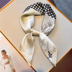 Elegant horse print and houndstooth pattern square silk scarf displayed on a stylist tray