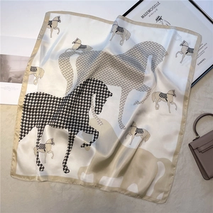 Detail of elegant horse print square silk scarf with houndstooth and champagne gold edges
