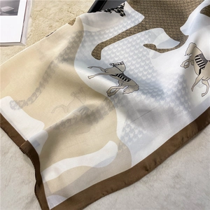 Detailed view of horse and houndstooth print satin scarf with elegant chain pattern