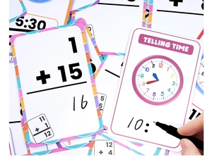 Close-up of erasable math and clock flashcards with a pen for early education