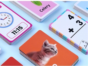 Close-up of thick educational flashcards with rounded corners showing animals and math
