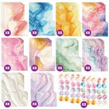 Flat lay of colorful marble textured stationery set with envelopes and seal stickers