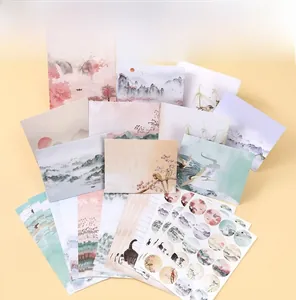 Flat lay of retro ink landscape envelopes and stationery paper with sealing stickers