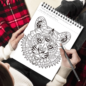 Relaxing adult coloring book with spiral binding featuring detailed tiger zentangle patterns