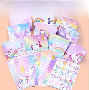 Flat lay of rainbow unicorn stationery set including envelopes, paper, and seal stickers