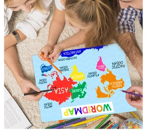 Educational world map poster for kids on a soft rug during a family learning session