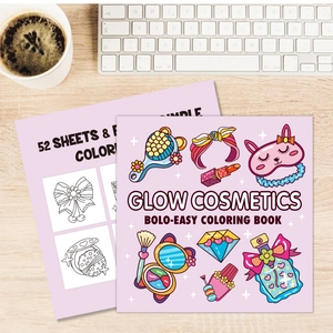 Glow Cosmetics coloring book with 52 cute makeup pages on a wooden desk with keyboard