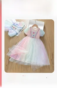 Detail of pink rainbow tulle girl's dress with sequin heart and puffy mesh sleeves