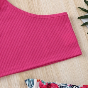 Close-up of girls ribbed knit camisole top and tropical floral print shorts fabric